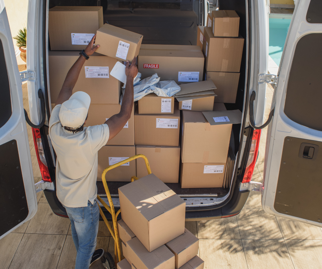 Boxed goods being loaded into a delivery van